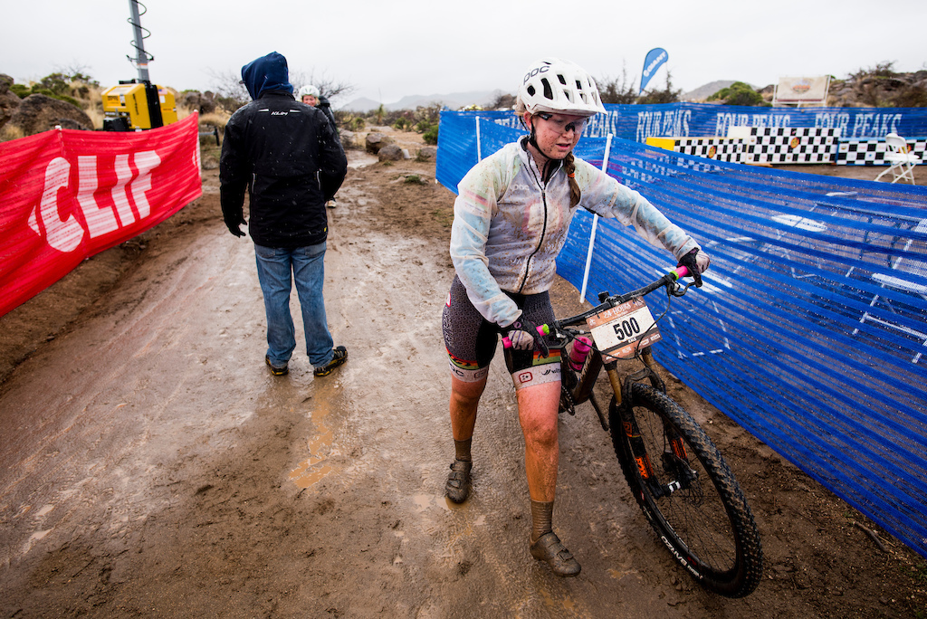 A racer walks through the exchange tent after  muddy lap Sunday morning during 24 Hours in the Old Pueblo.