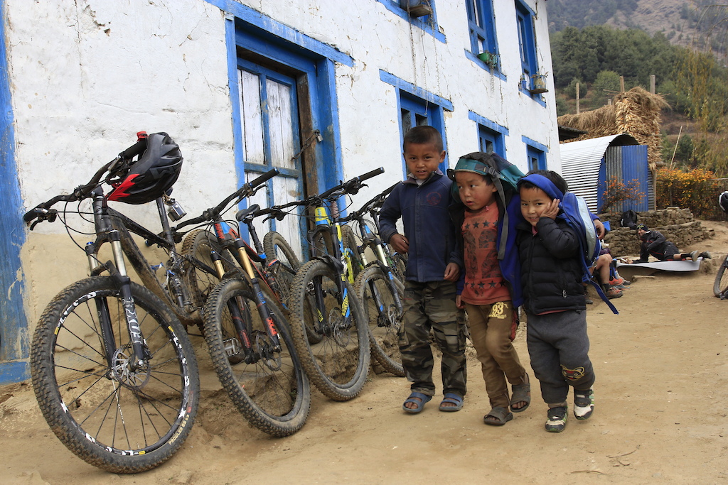 Curios Local kids are a feature of any trail when mountain biking in Nepal.