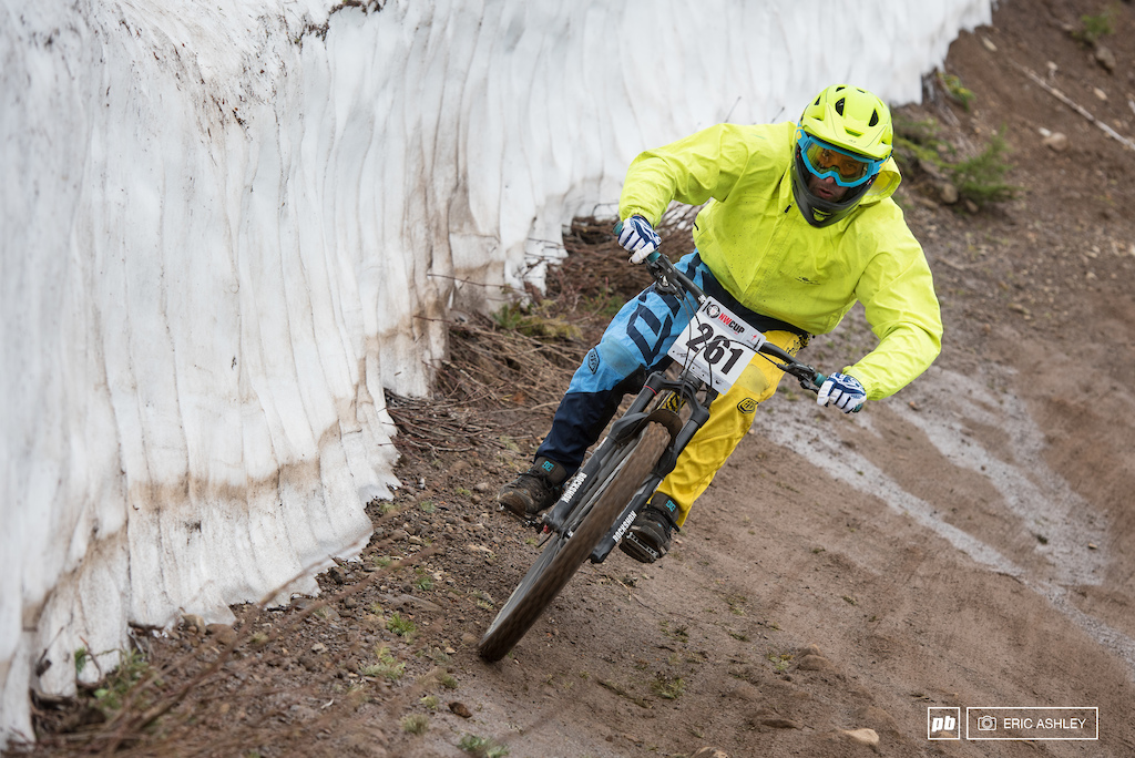 Chris Waller rides along a steep bank of meling snow on the bottom of Cannonball Cat 2 Men 30-39 .