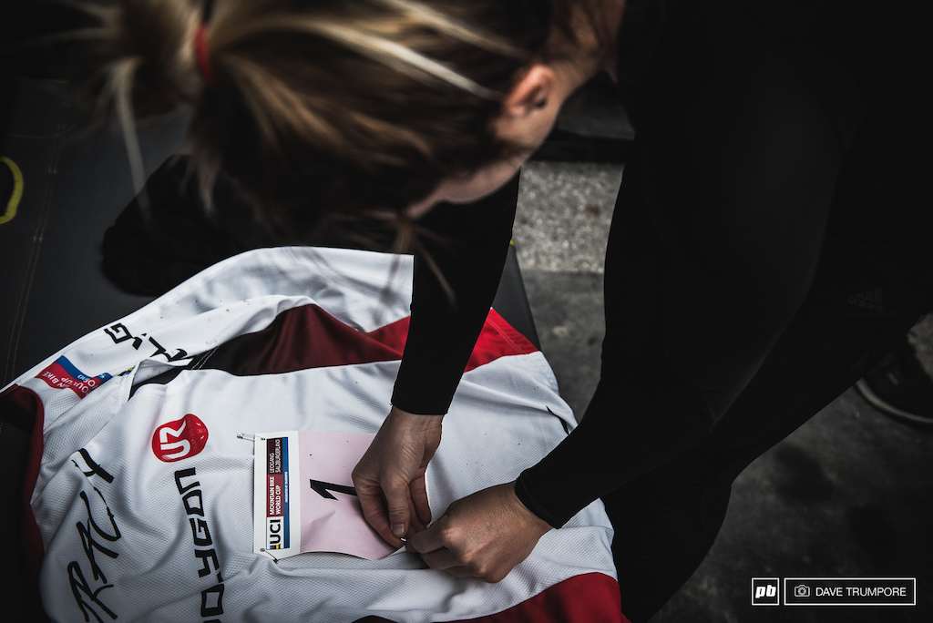 Tracey Hannah taking a few minutes to enjoy pinning the number one plate onto her World Cup leader's jersey. It's been a while since we've seen anyone but Rachel Atherton in this piece of kit.