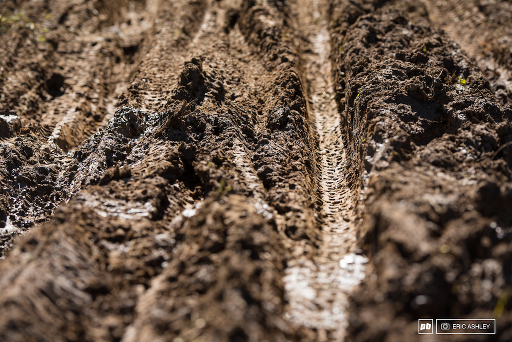 Remnants of Friday s deluge lingered on in the form of a deeply rutted turn that did it s best to suck riders into the grooves.