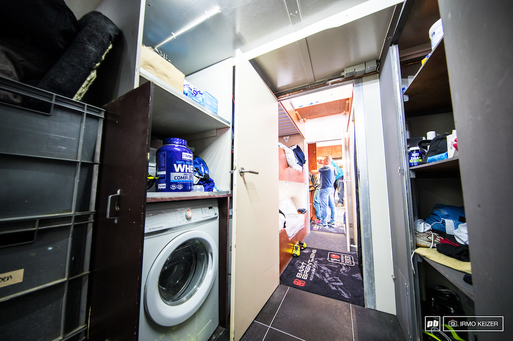 Spare parts, provisions, water bottles, tyres and a washer/dryer setup.
