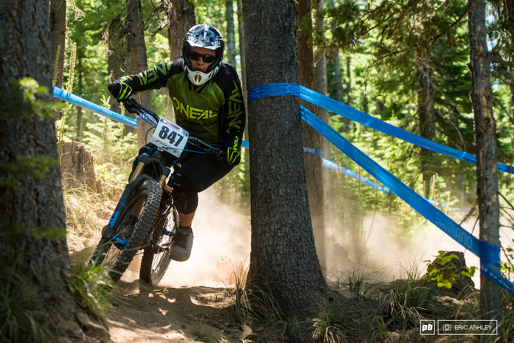 Cameron Llyod cuts it close through the trees near the bottom of the course Cat 2 Men 30-39 .