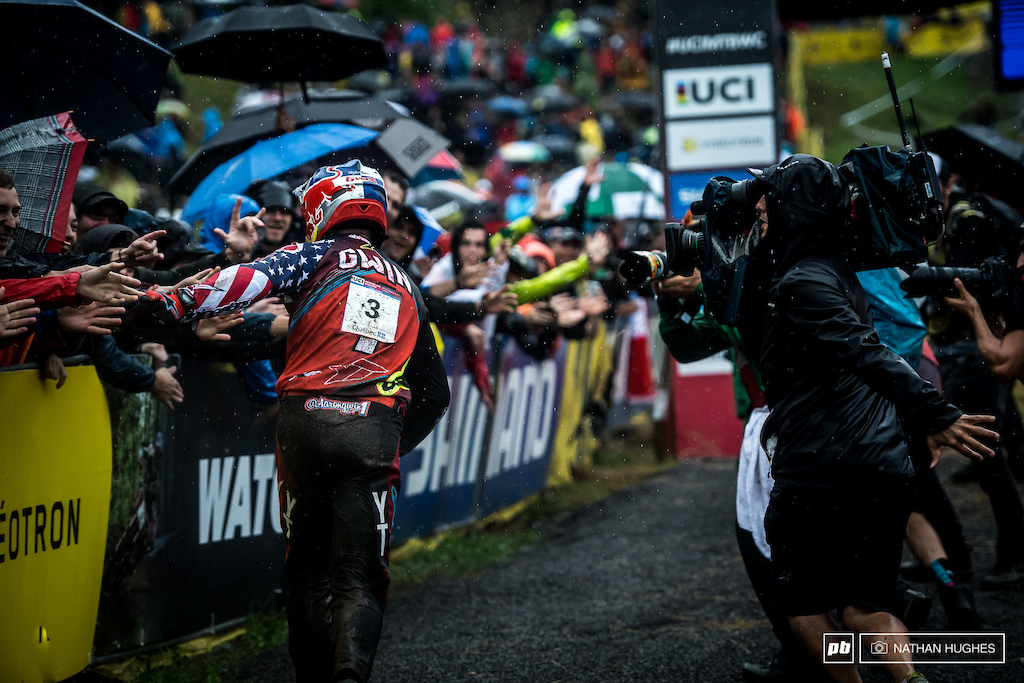 Gwin sheds the bike to celebrate in the still pouring rain.