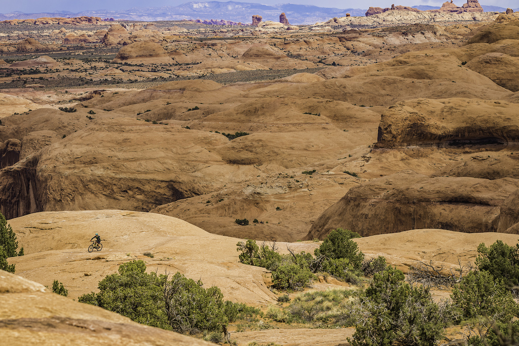 A lone rider exploring the slickrock of Moab, Utah.