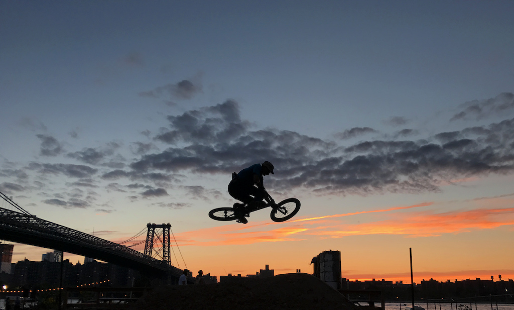 Dylan riding an evening session at the Velosolutions Brooklyn dirt jumps and pump track.