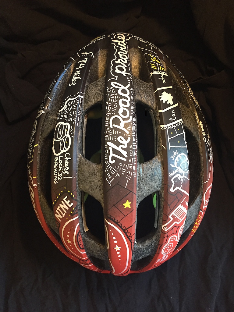 Custom helmet with art chronicling riders cross country bike tour. Instagram of the tour at @9mph_