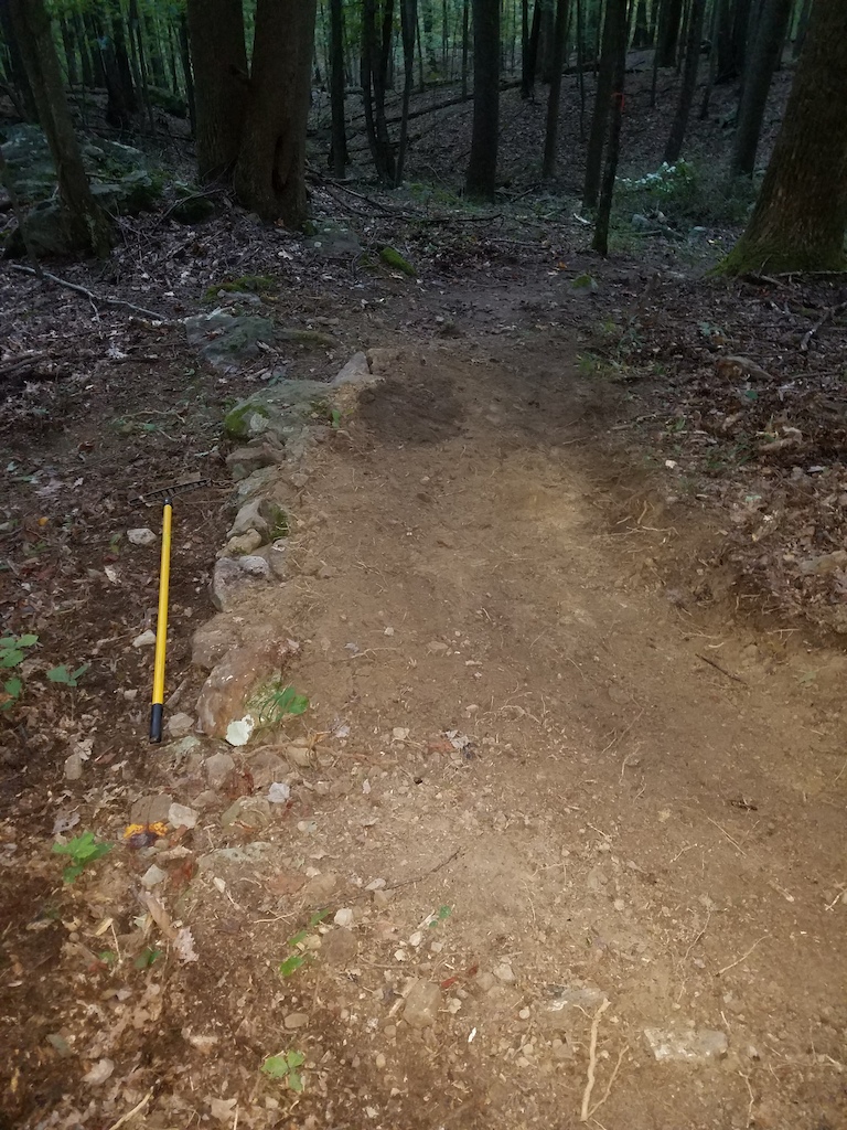 bench cut after the main rock garden.  bad hardpack, off chamber corner improved.  Looking down trail. Still a flat turn in the exit, but no longer off chamber entering.