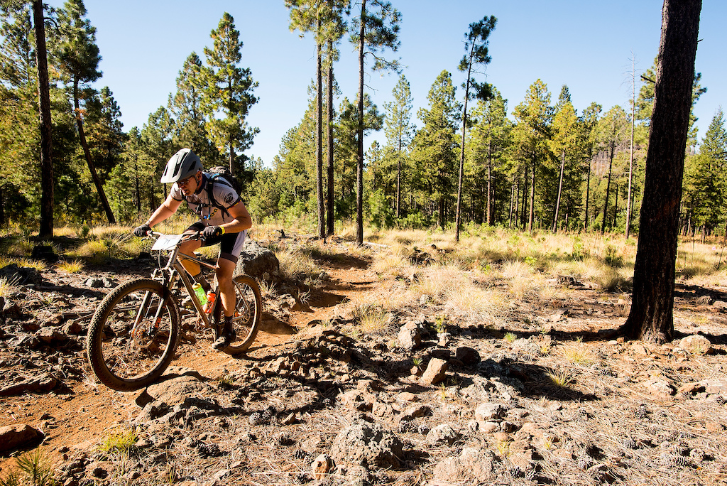 A racer climbs a rocky section of the Los Burros trails.