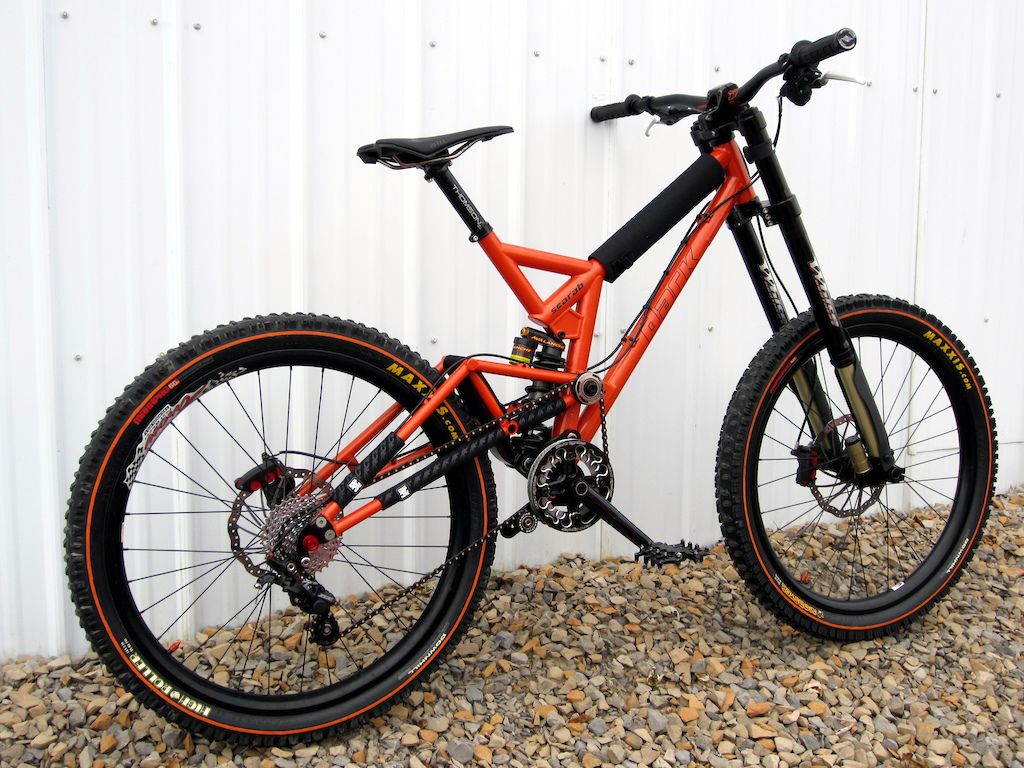 *FRAME: Dark Cycles Scarab  w/ Avalanche Chubbie 8.75x2.75 offset bushing
*FORK: White Brothers Groove 200 DH 
*WHEELS: Arrow Racing DHX rims laced to Atom Lab Pimplite hubs W/ DT spokes
*TIRES:  Maxxis Mobster 2.7 F High Roller 2.5 R orange line
*BRAKES:  Maguar Gustav DH 210 F / 190 R
*SHIFTER:  Shimano Zee 10
*R/DER:  Shimano Zee 10 Rear Derailleur   
*CASSETTE: SRAM 10 speed 11-32 Cassette PG1070
*CHAIN: Connex 10s Black Gold 
*CRANKSET: Profile Racing 170 w/ 4 bolt spider
*CHAINRING: RaceFace DH 36t 
*GUIDE: Dark Cycles w/ bash ring Envy
BOTTOM BRACKET: Profile Racing external
*SEATPOST:  Thompson Elite 30mm black
*SEATPOST CLAMP: Woodman Deathclamp 
*SADDLE:  WTB High Tail Ti
*GRIPS: Intense Lock On, Straitline endcaps black  
*BAR:  Chromag Fubars OSX 25mm Rise and 780, 31.8 Black Tight Orange
*STEM: Dark Cycles Cog &amp; Ax 31.8mm  
*HEADSET: Works Components 1 Deg
*CABLES &amp; HOUSING: Jagwire L3 
*PEDALS:  Dark Cycles Arachnid Pedals