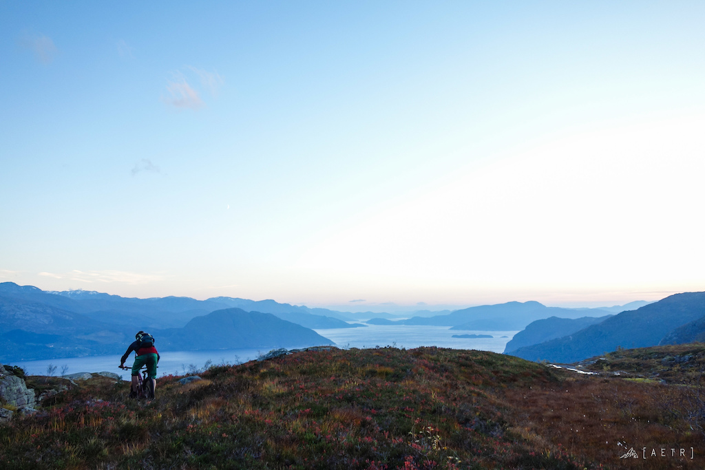 Jan riding into the late evening sunset over Hardangerdjord up in Norway after a ride exploring new trails up Grubbafjellet.