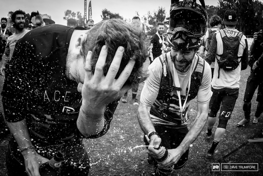 Iago Garay gives Jesse Melamed a cold beer shower to wash off the just in the finish area.