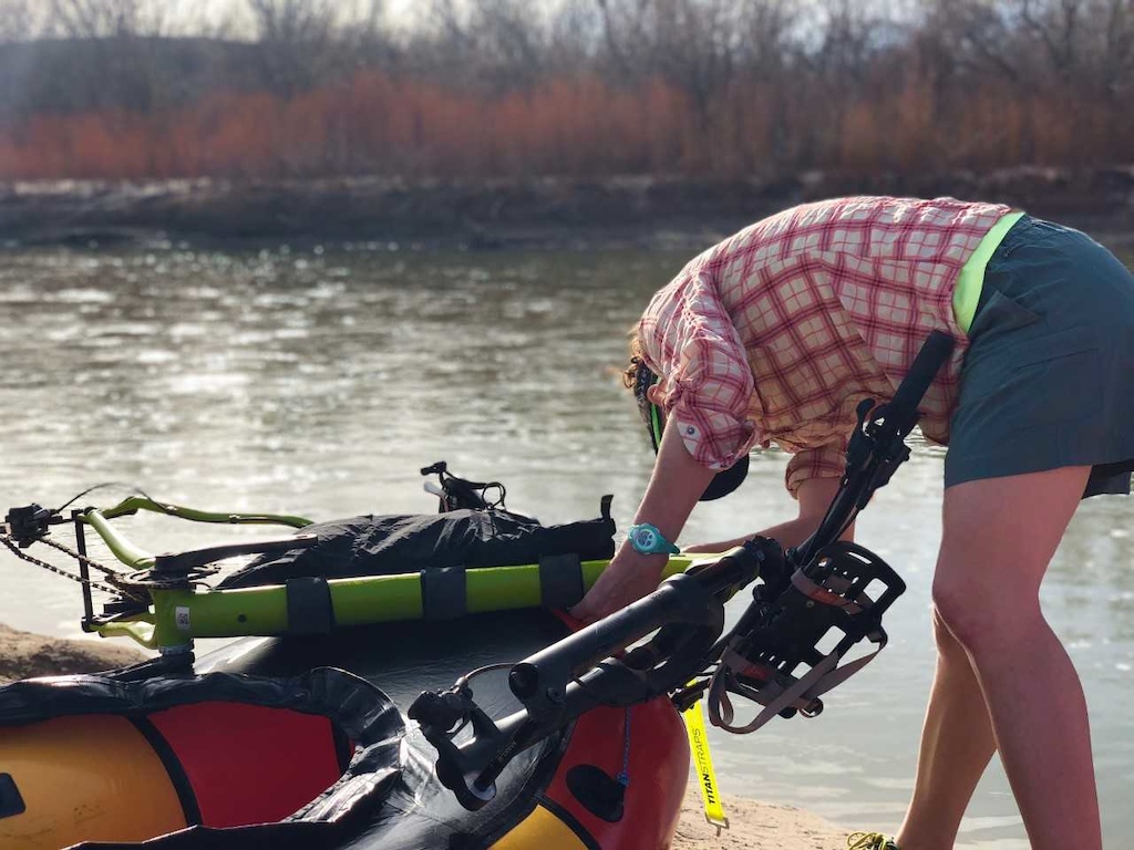 Diana Davis shares her expertise by showing us how to attach her bike to the front of her raft on the San Juan river portion of the trip. Photo by Sarah Tingey.