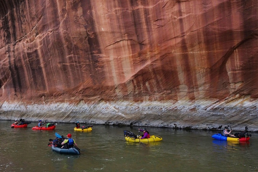 Little boats beneath towering walls on the San Juan River. Photo by Molly Harrison
