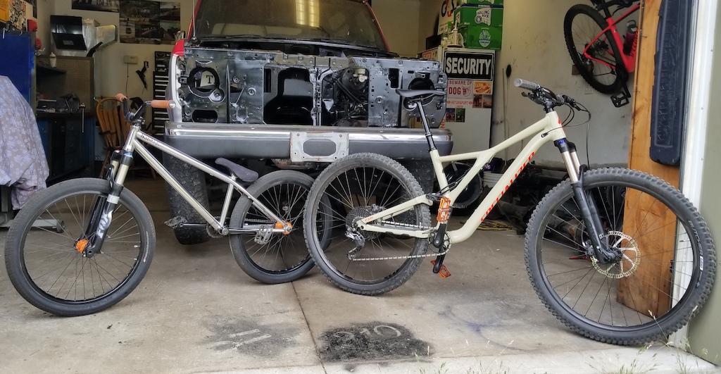 Finally got a picture of these 2 together. It's crazy the difference in the bikes and riding style. Look how small the 24" wheels are to the 29's!  I hopped on the old NS today and it felt pretty foreign after riding the Stumpy so much lately but after a few minutes I was more comfortable and able to pull a few tricks on it.
