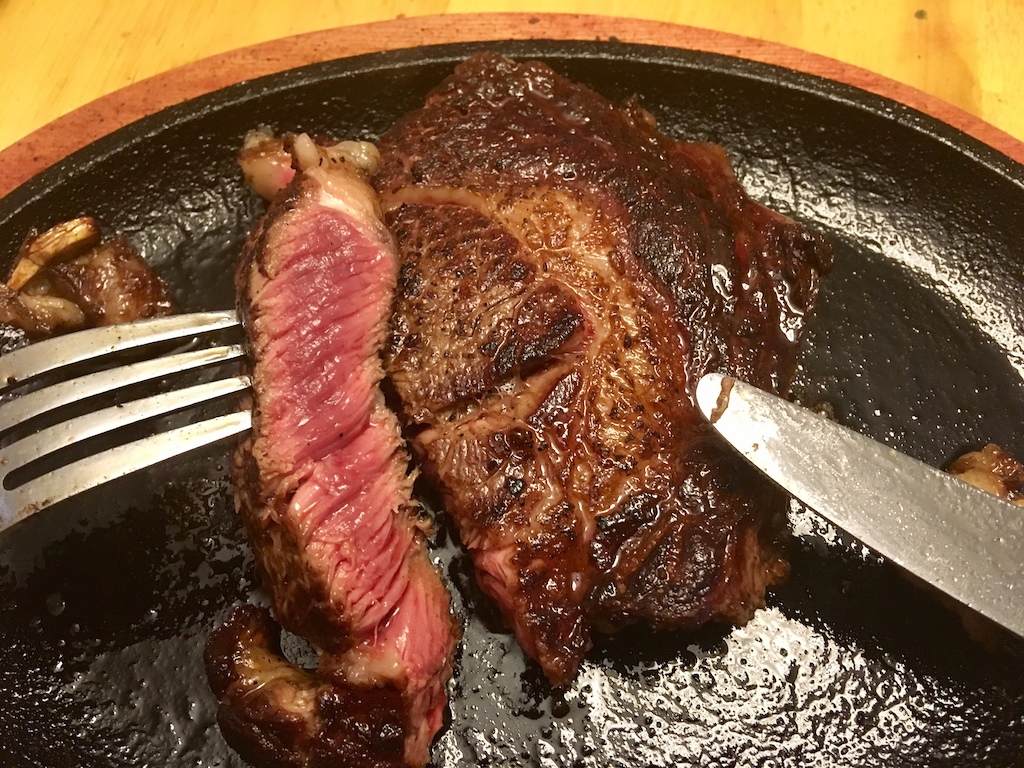 What true medium rare should look like - pink inside but charred outside and hot enough to melt fat, for maximum beef goodness.  Why can't paid chefs at "Steakhouse(s)" cook steaks properly when I can?  

I'm sick and tired of being served overcooked chewy pieces of leather when I order my steaks bloody rare.