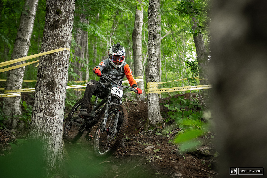 Heather Munive tries her best to keep bike and body in sync down the steep switch back corners in the final woods.