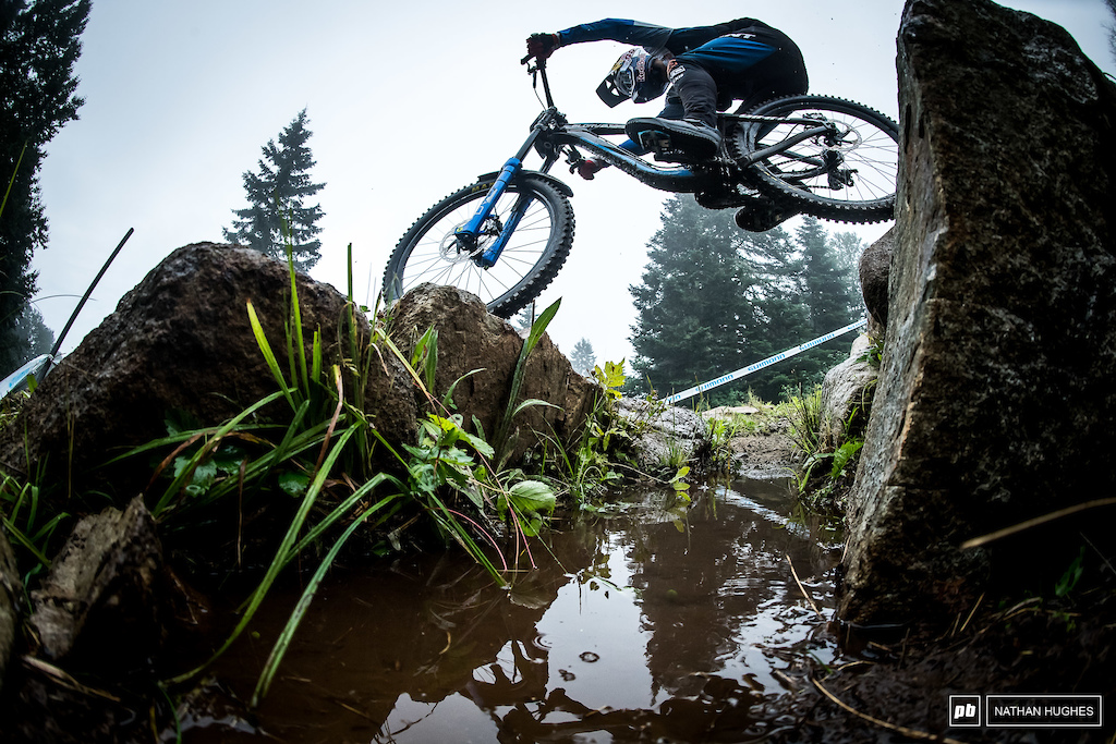 Marcello Gutierrez hops from one section of waterlogged trail to the next.