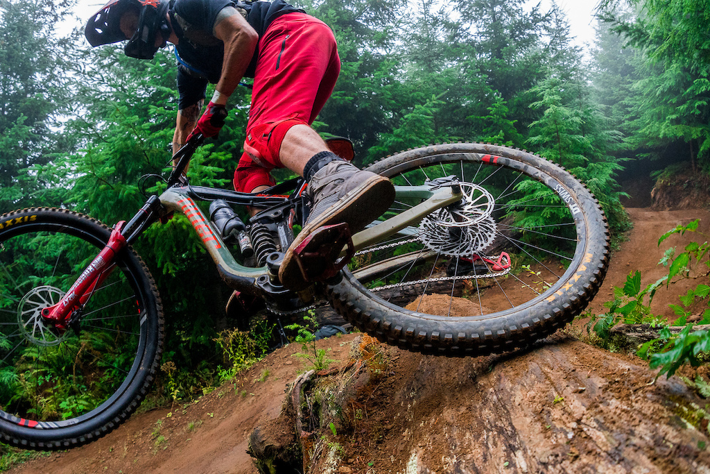 Kirt Voreis doe a tire slide on a log on his mountain bike at Galbraith Mountain near Bellingham, Washington.