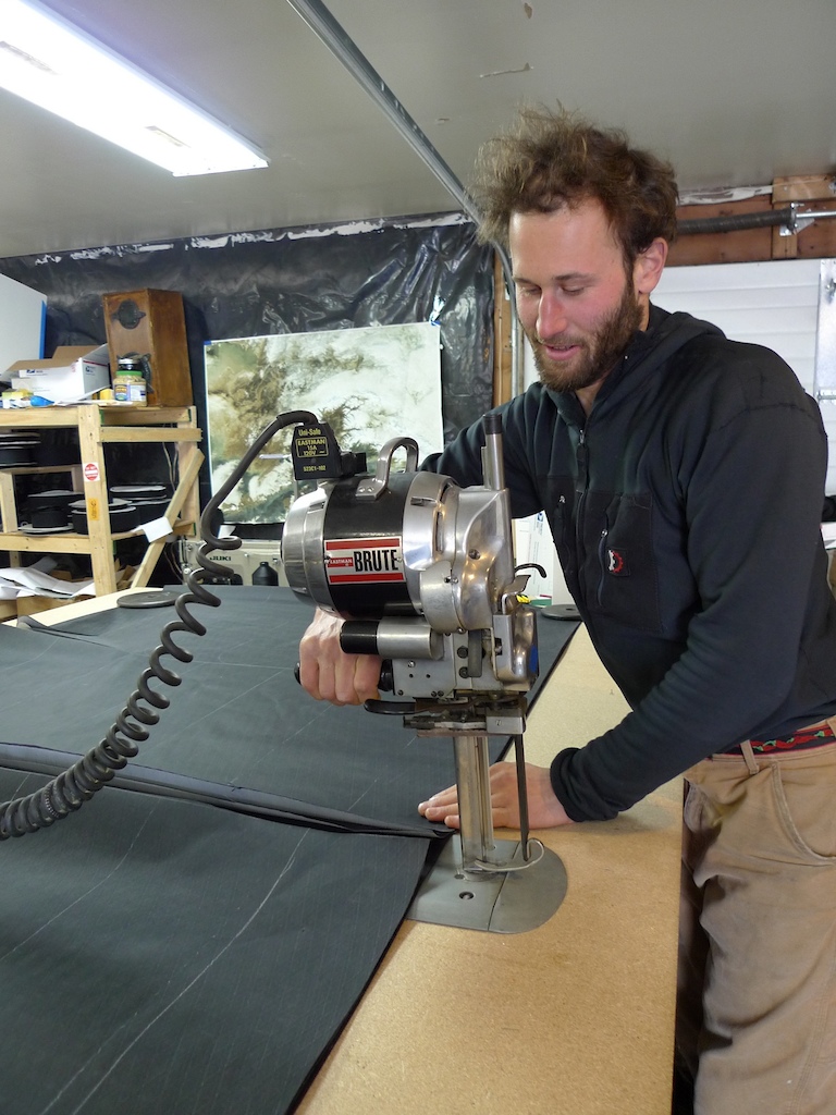 Eric Parsons using the first piece of industrial cutting equipment purchased for Revelate.