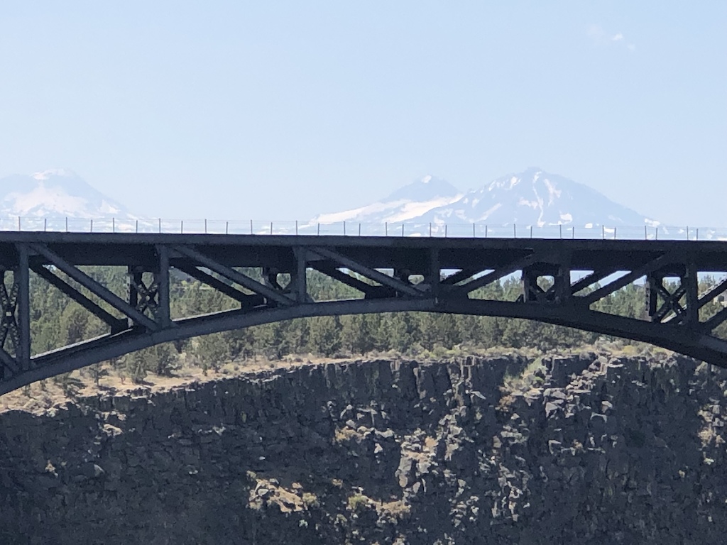 Railroad bridge over gorge, mountains in the background