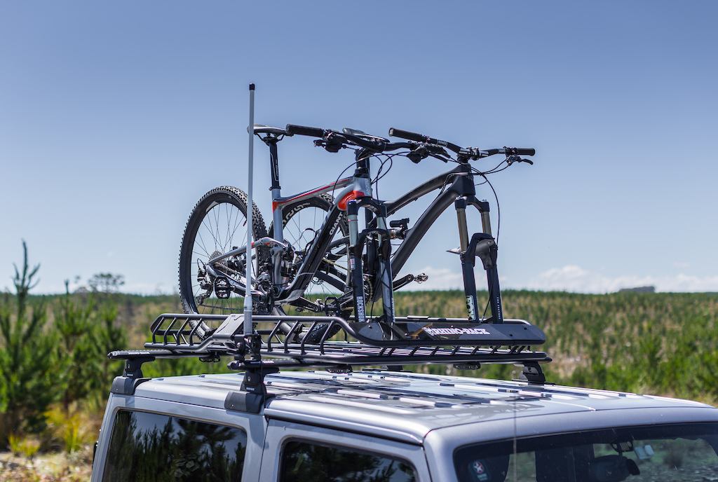 Rhino-Rack X-Tray Pro mounted on a Jeep with two mountain bikes on top.