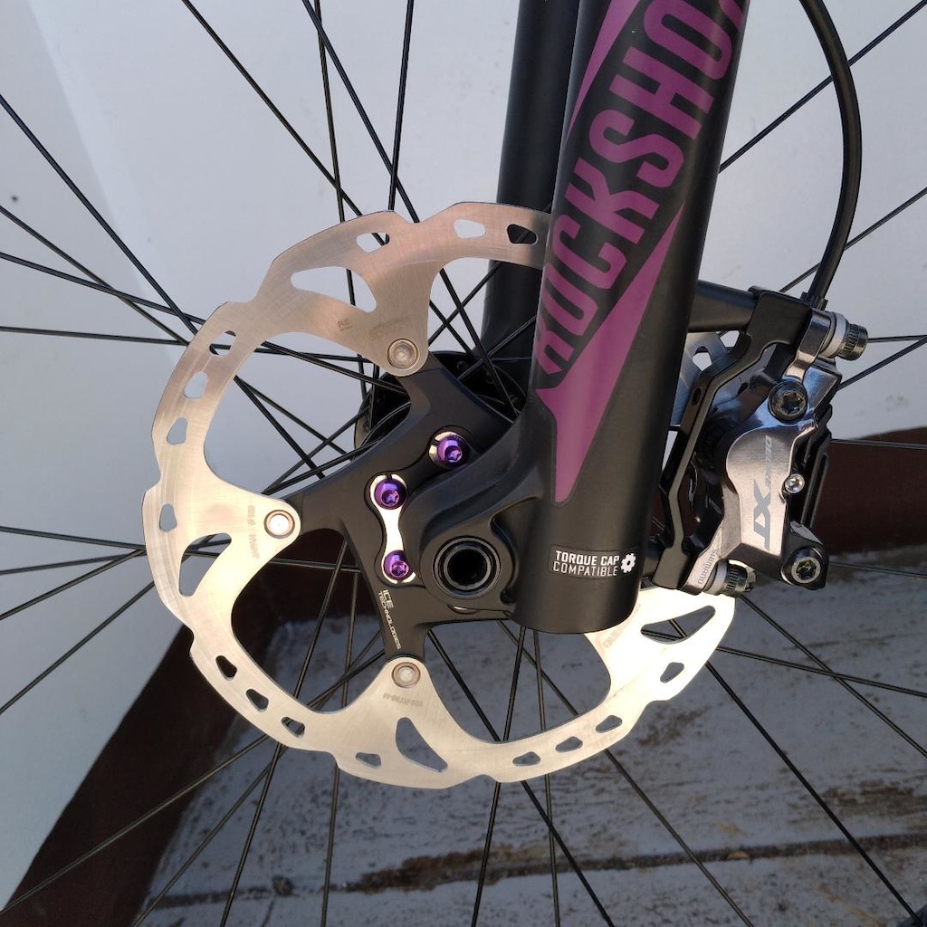 Front XT M8120, 4-piston Caliper with 180mm ICE Tech Rotor mounted. You can see the purple "Bling"  (rotor bolts).