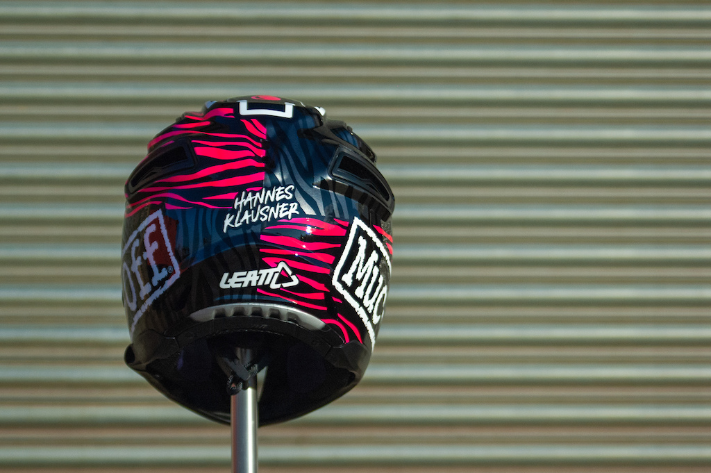 Custom painted Muc-Off helmet for Hannes Klausner. Fluorescent pink and gun metal zebra stripes with Muc-Off and Leatt logos.