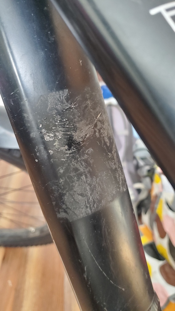Paint damage from old bike rack. Some sticker residue left on the frame too.