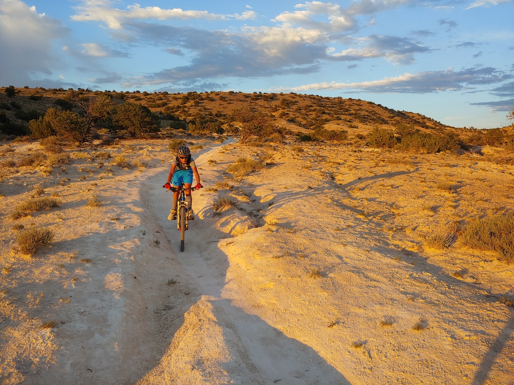 me descending down chalk dust in the sunset. august. best trail in placitas bru