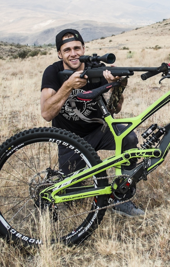 YT Bikes athlete with skull shirt and rifle.