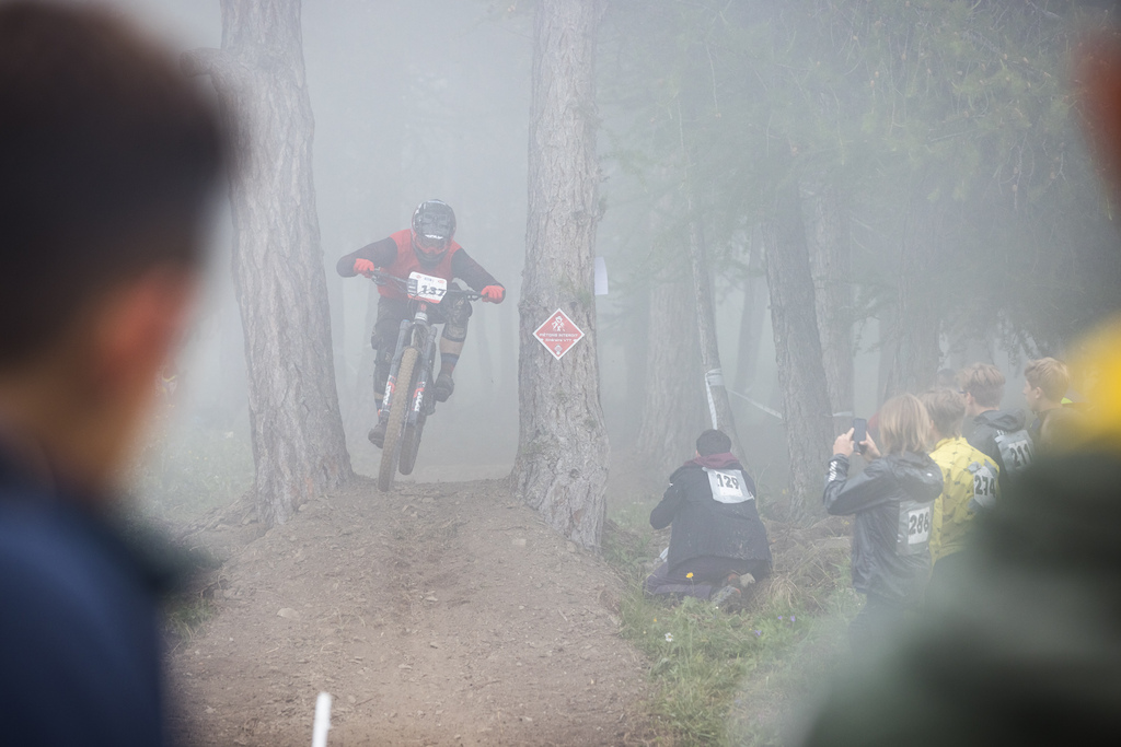 Quentin Lepine full gaz jumping out of the fog before crossing the finish line.