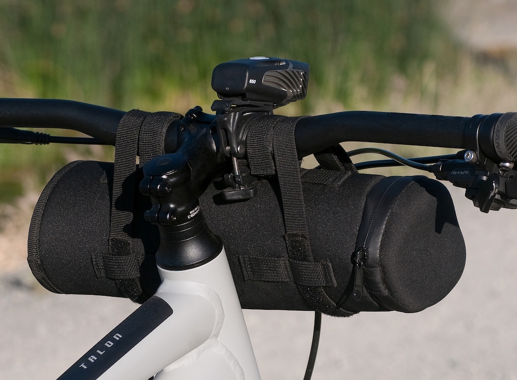Rock Gear brand storage case on mountain bike handlebars. Rear view.