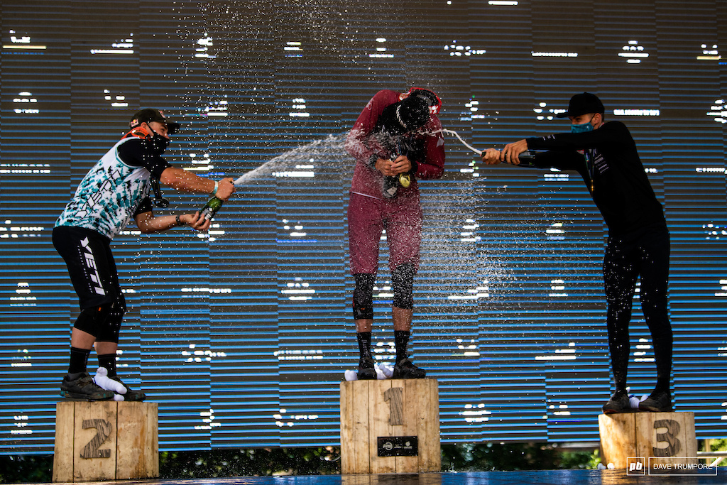 Richie Rude and Kevin Miquel help shower the dust and mud off race winner Jack Moir