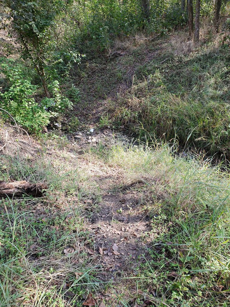 Roadrunner Trail - the ditch you have to cross.  Photo doesn't show how steep it  is. Most hikers/bikers stop at this edge and turn around.