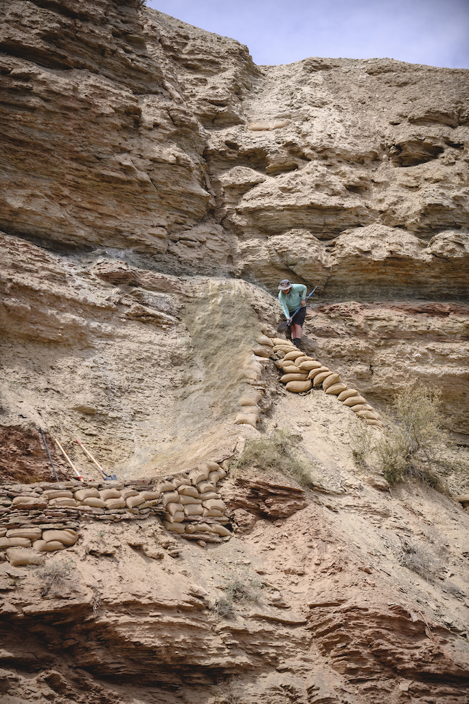 Hannah Bergemann works on a shared entrance from the ridge at Red Bull Formation in Virgin Utah USA on 10 May 2022