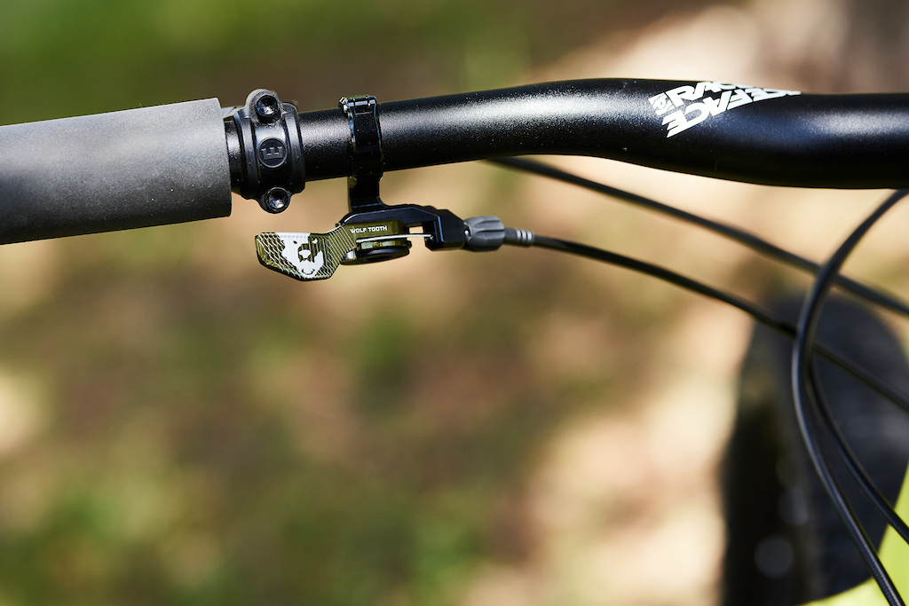 Wolf Tooth ReMote in Limited Edition Olive on mountain bike handlebars with Magura Brakes and Wolf Tooth Fat Paw Grips.