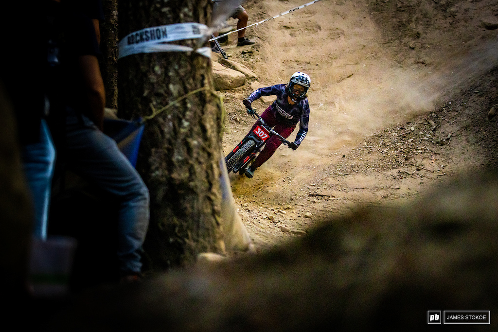 Canada's own Lucy Schick thrusting her bike into a structurally sound berm at the bottom of a steep, steep, rooty section.