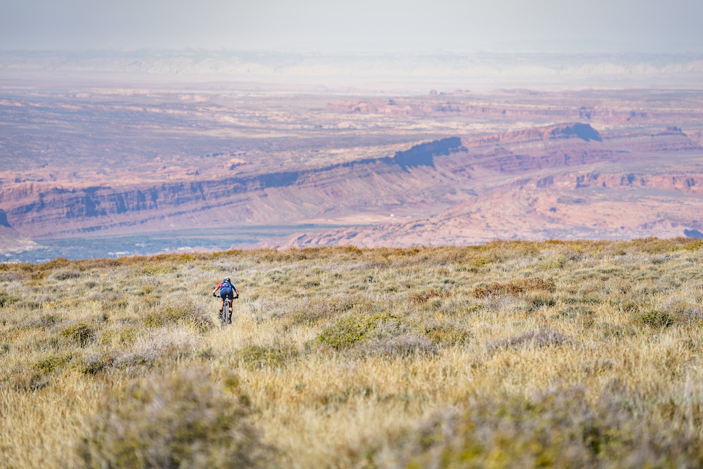 Hannah Otto descends the Hazard County Trail on her way to setting an FKT on "The Whole Enchilada" route, riding from town, into the La Sal Mountains and descending to the trail's end near the Colorado River, in Moab, UT.