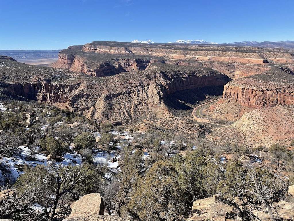 The Dolores River far below with the Paradox Valley peeking through.
