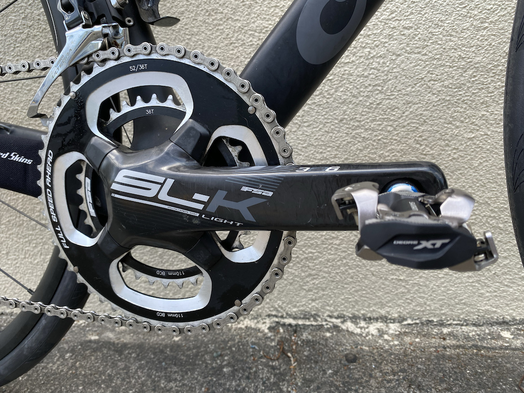 My 2018 Cervélo R3/Disk_FSA/SLK Carbon crank, and the Shimano Deore XT M8000 SPD XC Race Pedals,

Acording to the "Propaganda" by means of the Bike Radar Review of the R3/Disk -  By using a custom spec FSA/SL-K cranks and chainset with a 5mm offset to ensure the correct chainline, the R3 has managed to maintain short 405mm chainstays rather than having to shift to the 415mm recommended by disc brake manufacturers. This should help retain the bike’s race-ready handling while keeping the improved braking offered by discs. 

Trust me, I am not sure of the specific engineering involved,  but the bike keeps its awesome mix of aggressive geometry and super-low weight, all wrapped up in a whip-fast-handling machine.