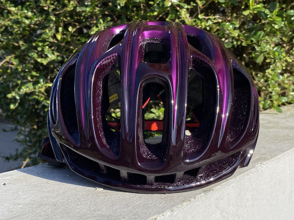 A tale of two helmets... Kind of. 

I custom painted this CairBull Road Helmet. That looks sort of different, depending if it is in direct sunlight or shade.  I started with a black helmet, Added sliver graphics, Then sprayed the whole thing will a translucent purple, to give the effect of two different colors of purple in the bright sun, or purple on almost blackout of the direct sunlight. 

This is a front view in full sun.
