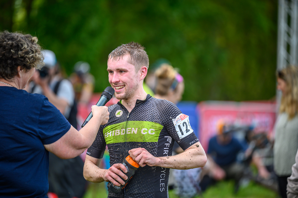 Joe Barker undertaking the winners duties of finish line interviews having taken the win in the Men s expert field