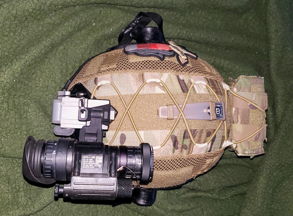 Own the night. Gen 3 PVS-14 GP L3 Harris with magenta filter making it look like a WP. Light on the top is a TNVC IR strobe so I don't get popped during live fire drills. Lvl3A lid in the high-cut fast style. Pouch at the back is for spare batteries and as a counterbalance to cut down on neck strain.