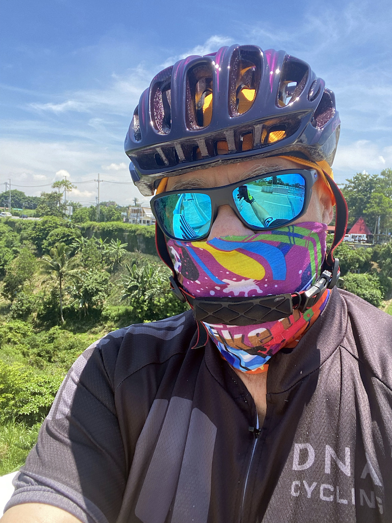 In Tagaytay, there is a lost of steam and ash still spewing out of the nearby TAAL Volcano, which erupted in January 2020.  So I wear a "Neck Sock" to keep the grit out of my nose and throat. 
*Oakley prescription UV shades
* Custom-painted CarBull Helmet.
* "Durag" under the helmet keeps this "Kalbo" (Shaved/Bald headed guy) from getting sunburned on the very open helmet, plus it helps keep sweat out of my eyes.