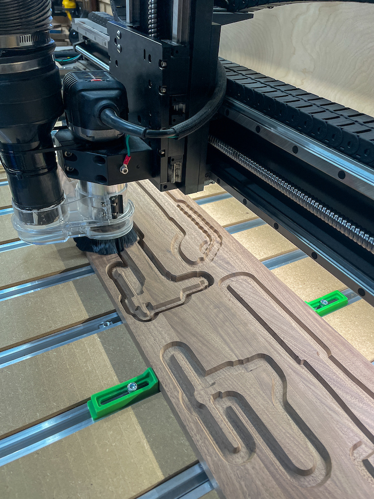 Tool Slugs: Each walnut "slug" was cut to match a specific tool. These are glued into the oak boards to act as visual placeholders and guides.