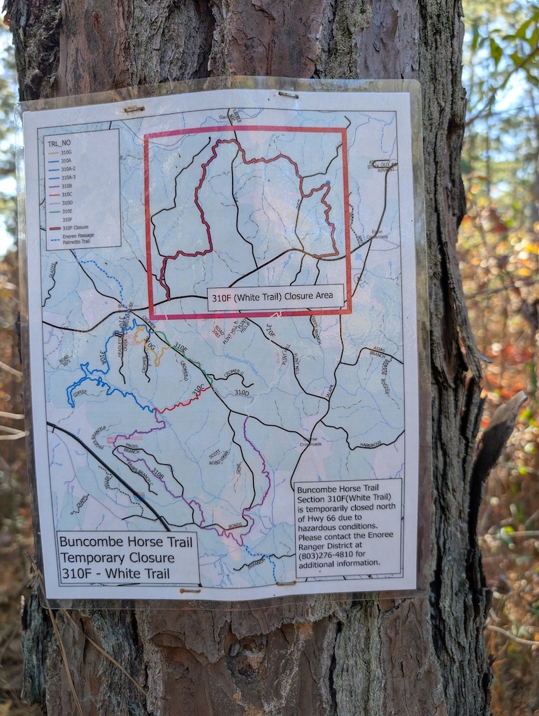 A trail map posted on a tree showing temporary closure area for White Trail.