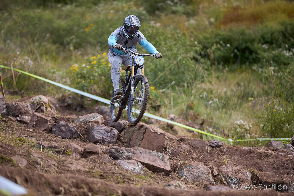 Hans Pulgar — Number 4 floats above the chaos like gravity is merely a suggestion. Launching off the Andean rock garden with effortless precision, Chile's finest reminds us that the best riders don't fight the mountain — they dance with it. Every stone becomes a launch pad, every obstacle a opportunity. When you ride with this much heart, the trail doesn't stop you; it sets you free