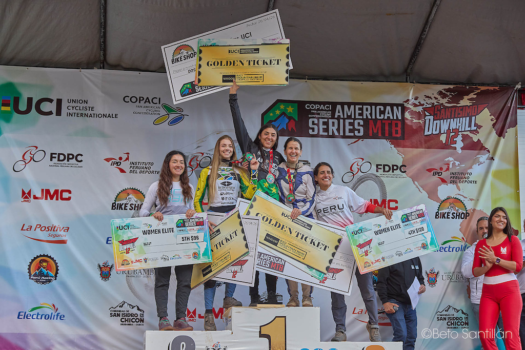 Catalina Calderón  — She didn't just win the race. She earned the GOLDEN TICKET.  The Women Elite UCI podium at Santísimo DH 12 — American Series MTB — and the Argentinian champion stands on the highest step of the Sacred Valley, Golden Ticket raised to the Andean sky, punching her pass to the UCI Mountain Bike World Series. Five incredible women who pushed the limits of what is possible on this mountain, but today belongs to Catalina — fearless, unstoppable, and now world-series bound. This is not just a victory. This is a destiny fulfilled. ¡La campeona voló alto hoy!