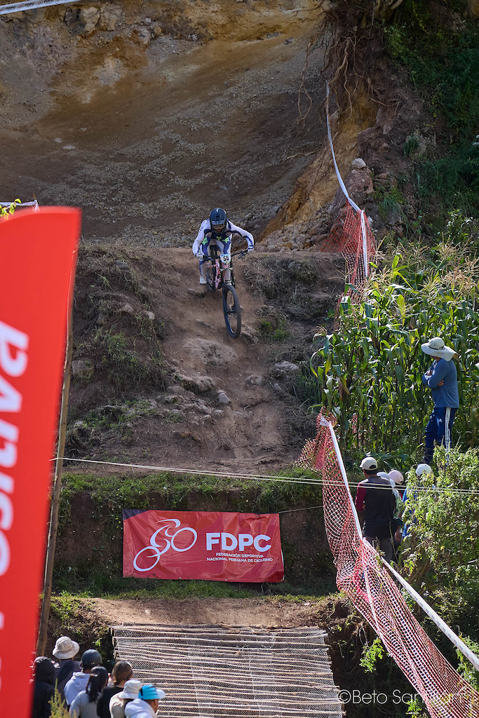 Katien Holde from the United States attacks the last brutal drop of the Chicón track at Santísimo Downhill 12 in Urubamba - Cusco, Peru, surrounded by ancient Andean rock walls, native cornfields and a crowd of passionate local spectators who have come to witness the very best riders on the continent throw themselves down one of South America's most unforgiving downhill courses. No fear. No hesitation. Just pure commitment at altitude. This is what it looks like when the world comes to race in Peru